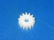 A white plastic .583 pitch gear on a blue surface.