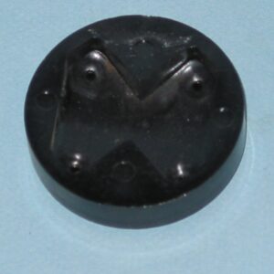 A black plastic "H" Detent button on a blue surface.