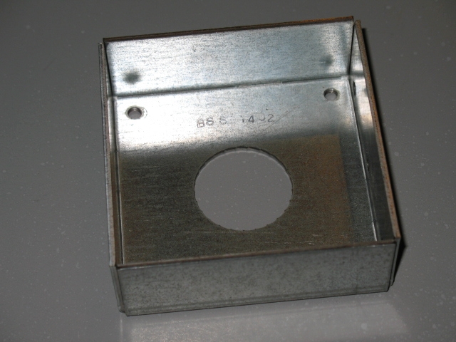 A metal box with a hole in the base.