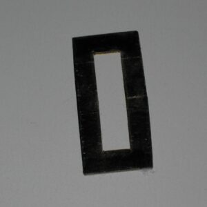 A black rectangular frame with a hollow center on a gray surface.