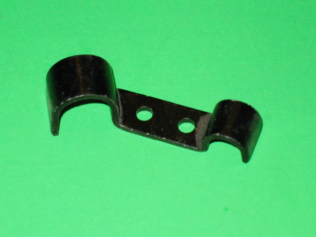 A black Bracket on a green surface.