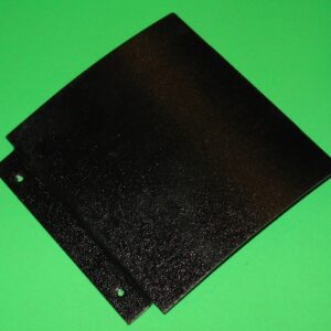 A black plastic Cover Plate on a green background.