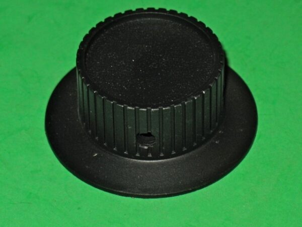 A 73-834 NOS Tempest or Warlords spinner KNOB on a green surface.