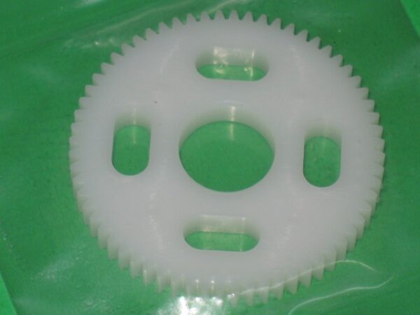 A Gear, 64 tooth on a green plastic bag.