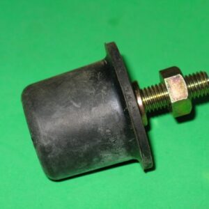 A black 601-5778 Stopper, Rubber and bolt on a green surface.