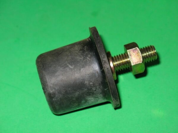 A black 601-5778 Stopper, Rubber and bolt on a green surface.