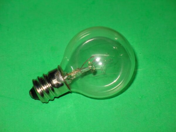 A 390-5157 bulb on a green surface.