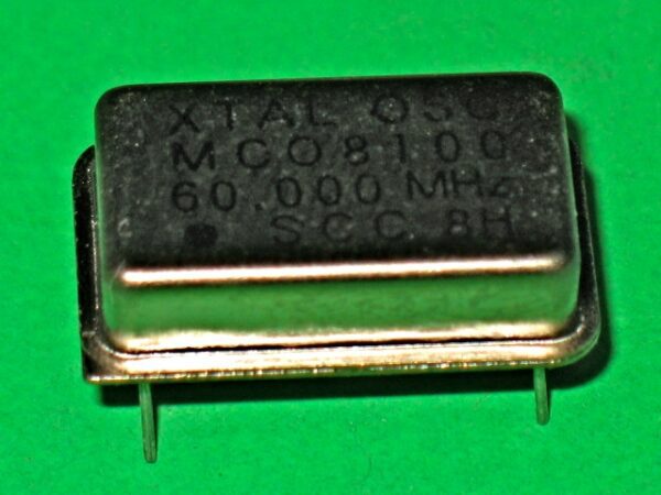 A 230-5053 53.693 MHz crystal on a green background.