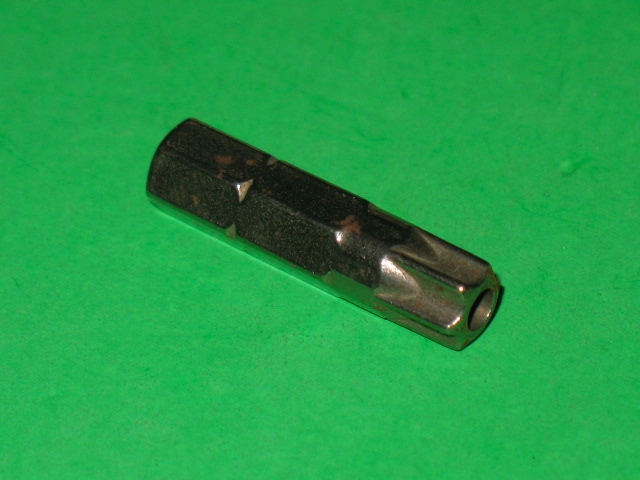 A small piece of 540-00011 on a green surface.