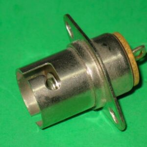 A small 214-0012 plug on a green surface.