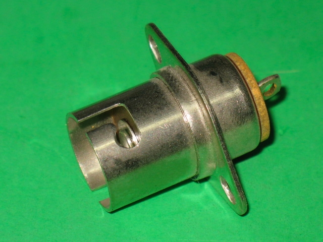 A small 214-0012 plug on a green surface.