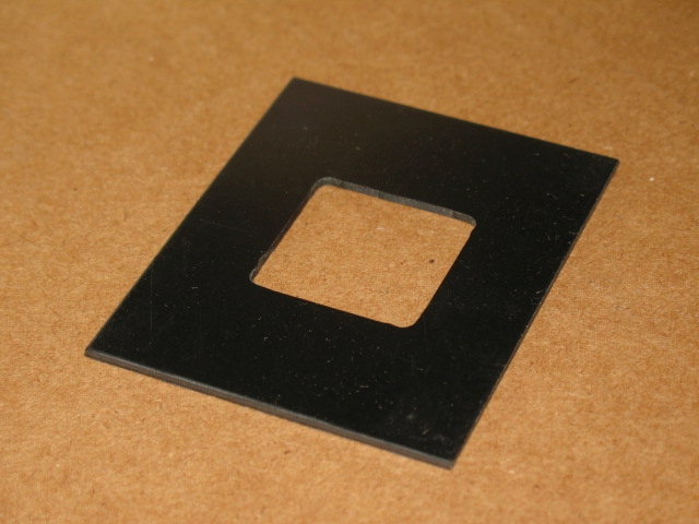 A square piece of plastic on a table.