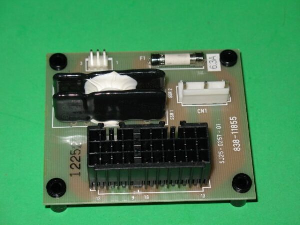 A small 838-11855 Relay board, Lost World with an electronic component on it.