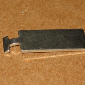 A small piece of 01-12369 shuffle on a brown surface.