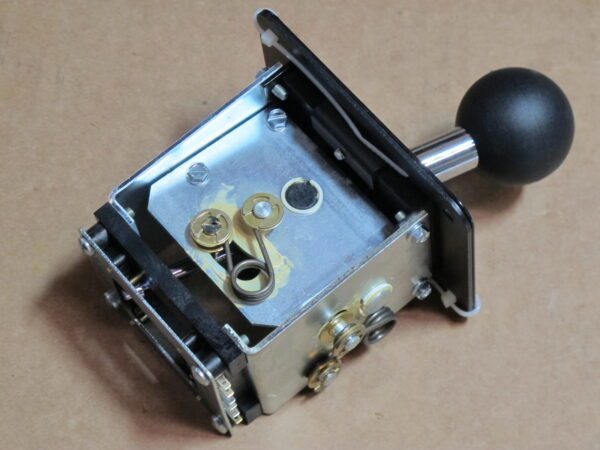 A metal 4 way shifter with a black knob on it, Happ Controls.