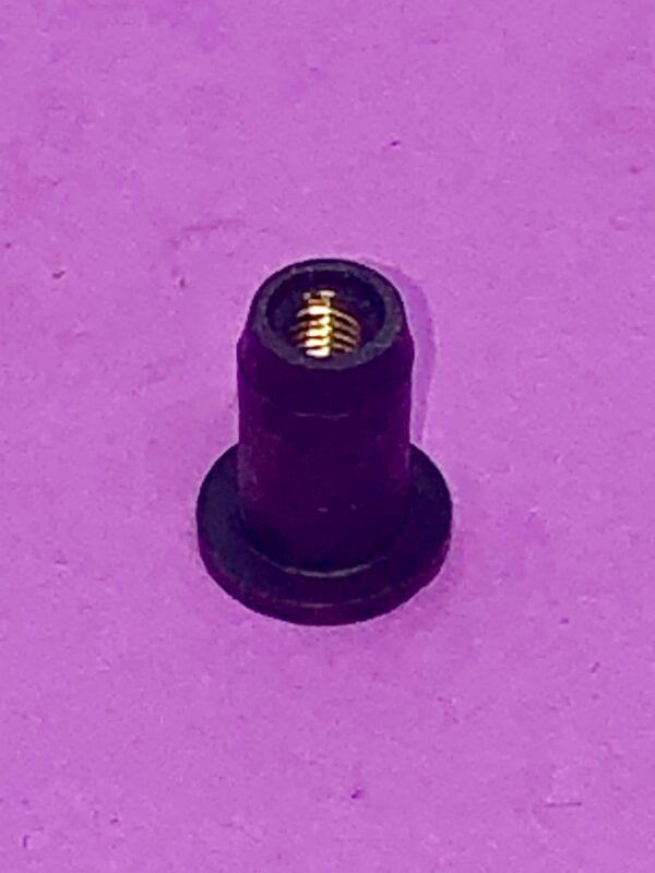 A Weld Nut on a purple surface.