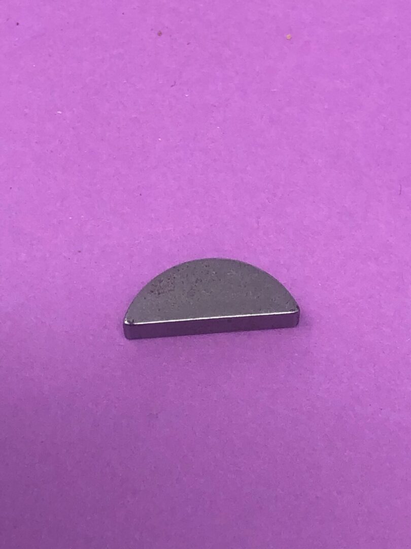 A small piece of metal on a purple surface.
Product Name (Chain): A small chain on a purple surface.
Product Name (Support): A small support on a purple surface.