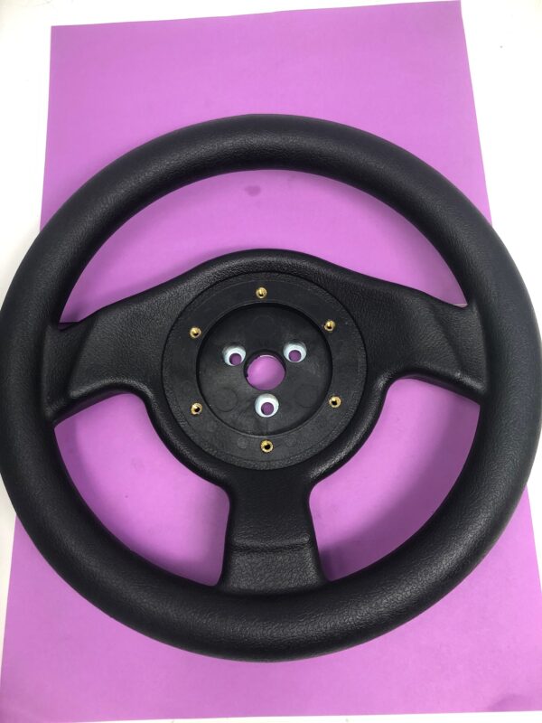 A black Crusin Exotica steering wheel on a purple background.