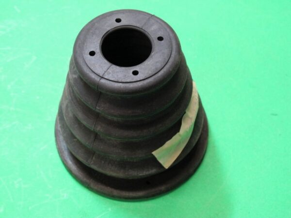 A black rubber cone on a green surface.