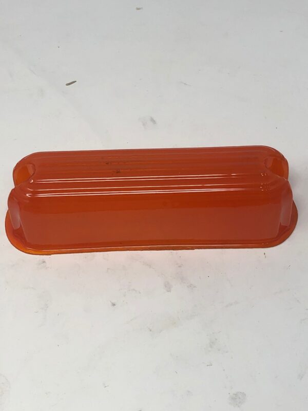 An orange plastic Win Lens container on a white surface.