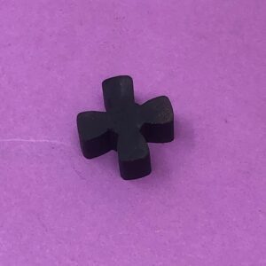 A black cross on a purple surface.