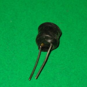 A small black coil on a green surface.