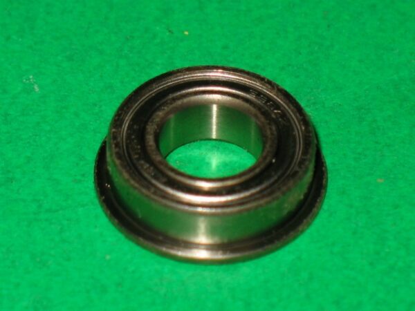 A 100-5041 bearing on a green surface.