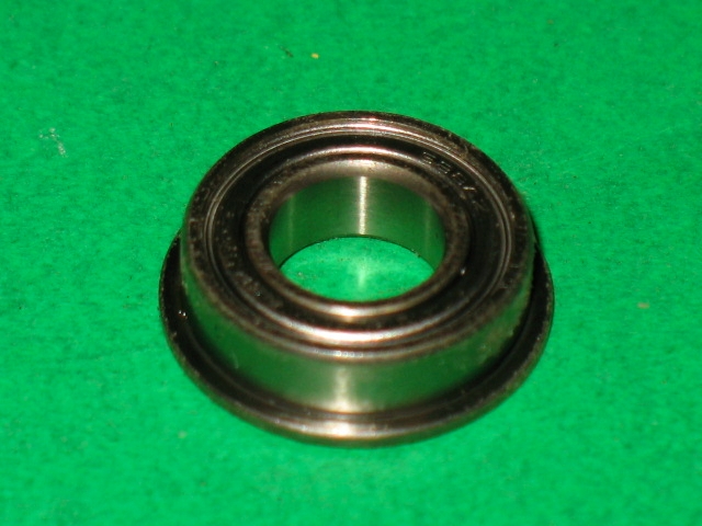 A 100-5041 bearing on a green surface.
