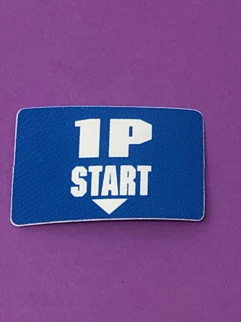A blue sticker with the word 1 Player Start on it.