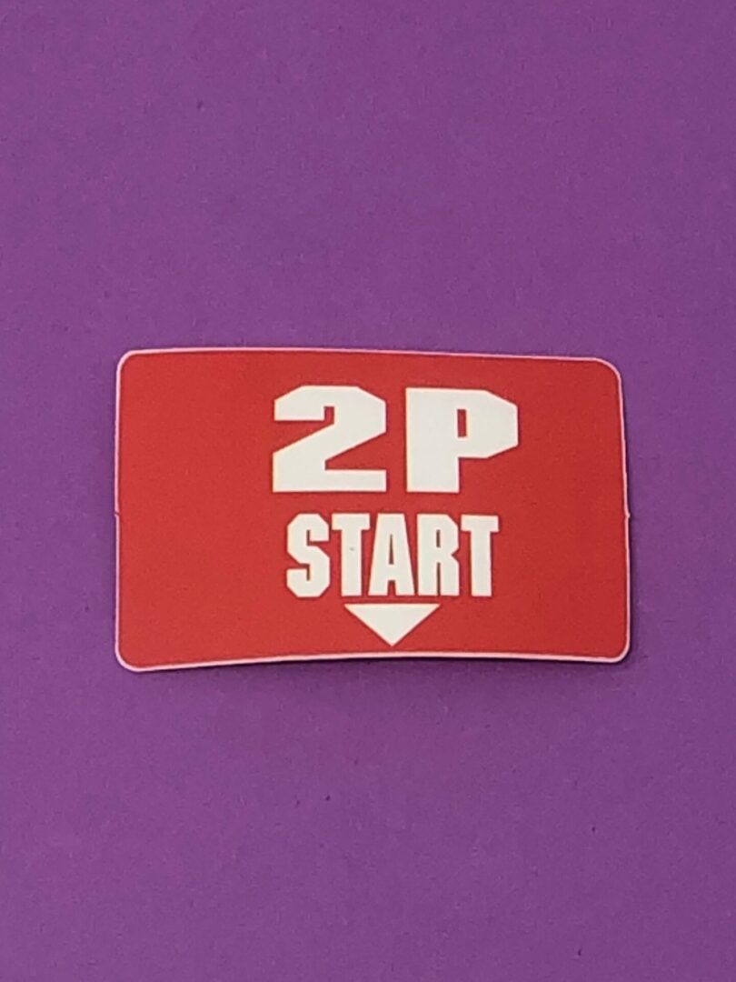 A sticker with the words 2 Player Start sticker, BBSN on it.