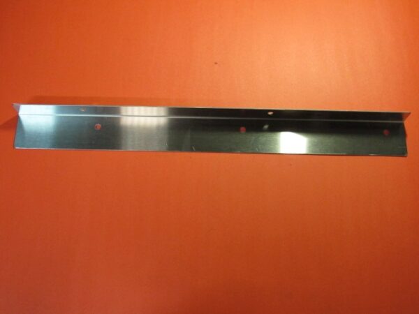 A Bulk Guard metal shelf bracket on an orange surface.