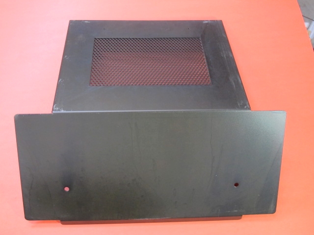 A black Brake Lid on a red table.