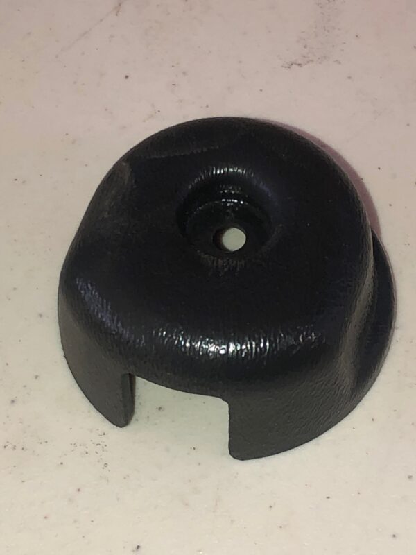 A black plastic Wheel Cover with a hole.