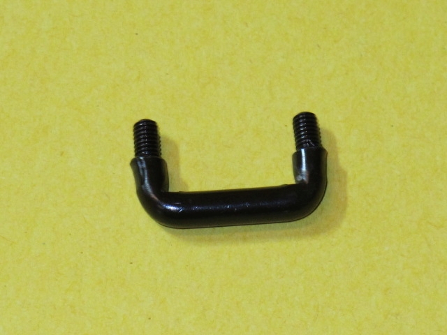 A black Hook, Security and bolt on a yellow surface.