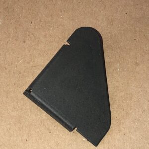 A black plastic bracket on a brown surface.