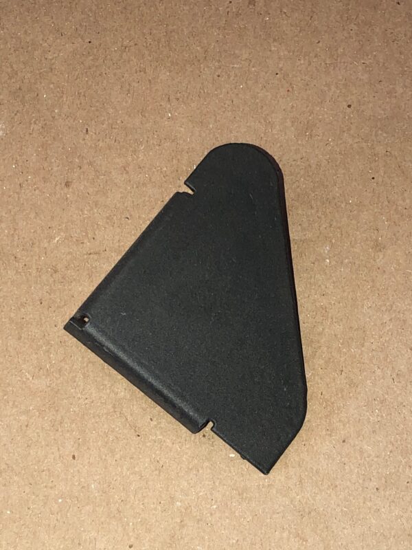 A black plastic bracket on a brown surface.