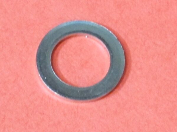 A stainless steel washer named Tube on a red surface.