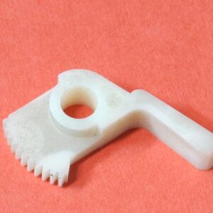 A white plastic Brake Gear with a hole in it.