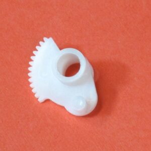 A small white Accel Gear on an orange surface.
