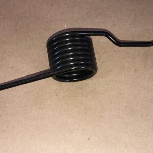 A black metal clutch spring on a table.