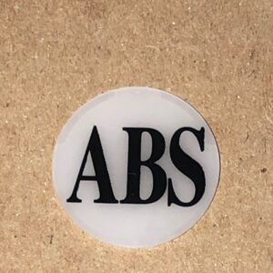 A ABS Button Cover sticker with the word abs on it.