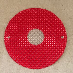 A red circular Rear Light Lens with a hole in it.