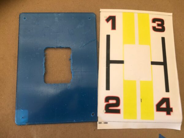 A blue and yellow Sifter plate, Nascar with numbers on it.