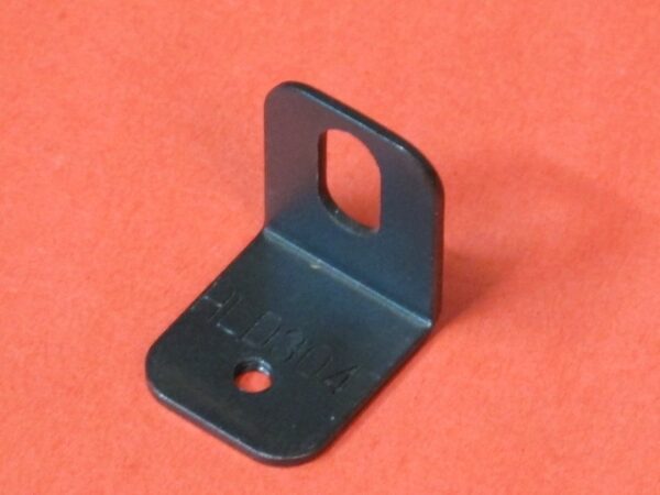 A black metal Bracket on an orange surface.