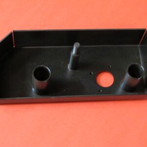 A black metal brake base with two holes on it.