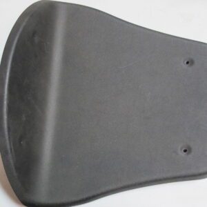 A black NOS Seat plastic, GP Rider cover on a table.