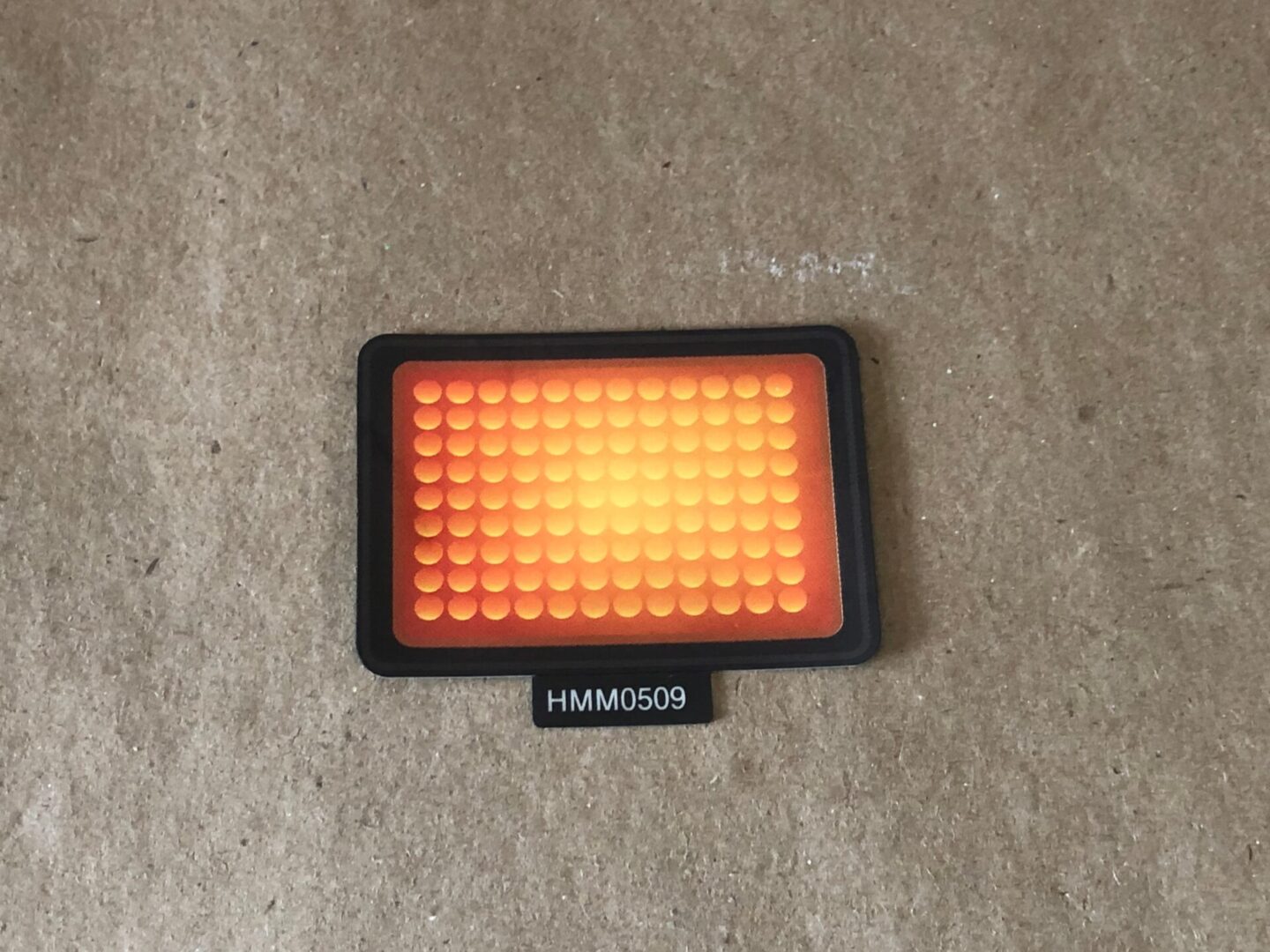 A square led sticker on a piece of paper.