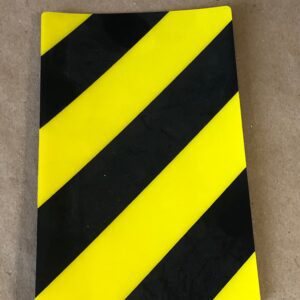 A yellow and black striped sticker on a table lid left.