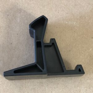 A black plastic Controller Hook on a table.