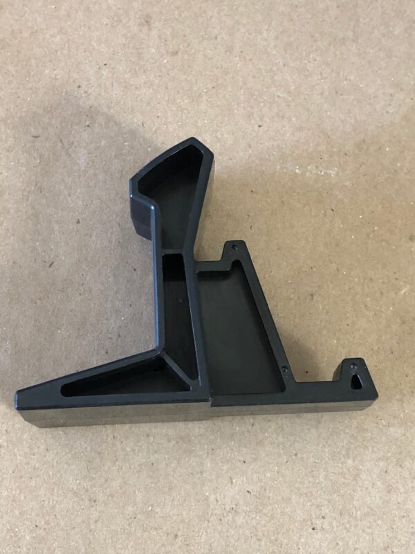 A black plastic Controller Hook on a table.